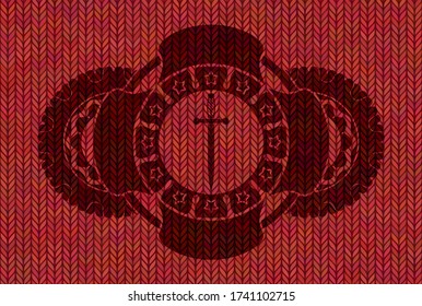 Sword icon inside Red color woolen fabric realistic badge. Cloth classic background. Illustration. 