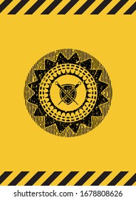 swords crossed with shield icon black grunge emblem with yellow background. Vector Illustration. Detailed.