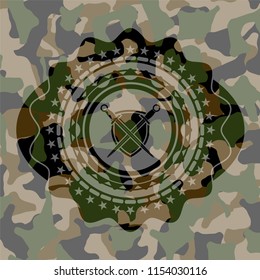 swords crossed with shield icon inside camo emblem