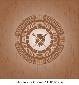 swords crossed with shield icon inside wood emblem