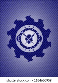 swords crossed with shield icon inside badge with denim texture