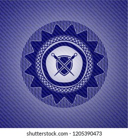 swords crossed with shield icon inside badge with denim texture