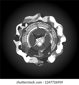 swords crossed with shield icon inside grey camouflage emblem