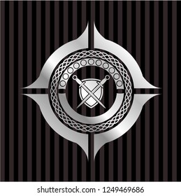 swords crossed with shield icon inside silvery badge