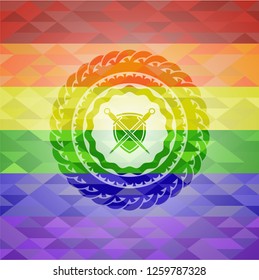 swords crossed with shield icon inside emblem on mosaic background with the colors of the LGBT flag