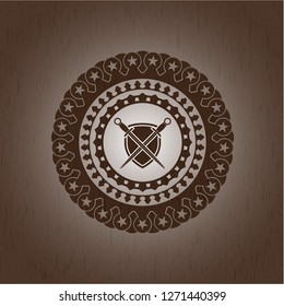 swords crossed with shield icon inside wooden emblem