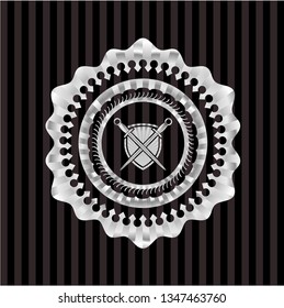 swords crossed with shield icon inside silver emblem or badge