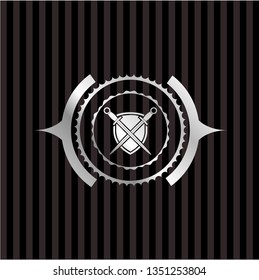 swords crossed with shield icon inside silvery badge or emblem