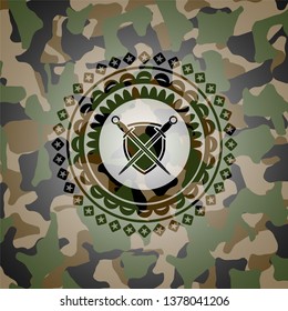 swords crossed with shield icon inside camouflage emblem