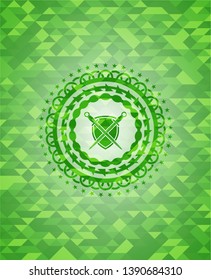 swords crossed with shield icon inside realistic green mosaic emblem