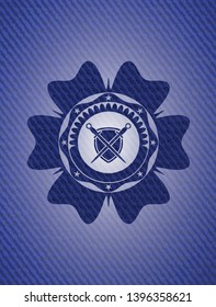 swords crossed with shield icon inside badge with denim texture