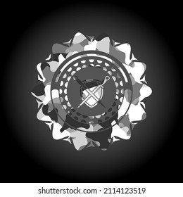 swords crossed with shield icon inside grey camo emblem. 