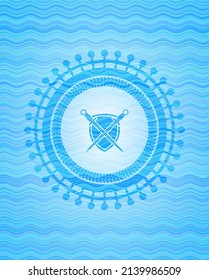 swords crossed with shield icon inside light blue water style emblem. 
