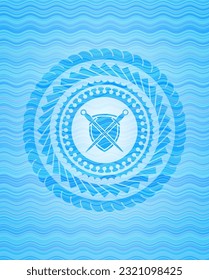 swords crossed with shield icon inside light blue water wave style badge. 
