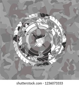 swords crossed with shield icon on grey camo texture