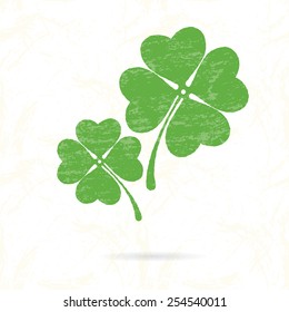 Symbol of clover with four petals on the background texture