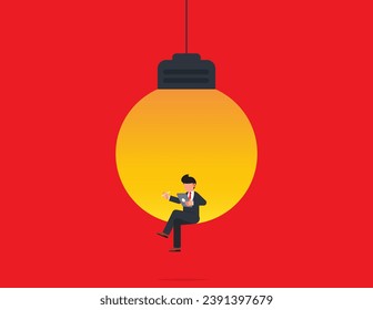 Symbol of creativity. Businessman sitting in light bulb with laptop.