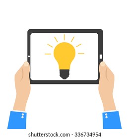 a symbol of the idea of light on the tablet in human hands