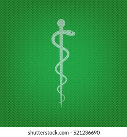 Symbol of the Medicine. white icon on the green knitwear or woolen cloth texture.