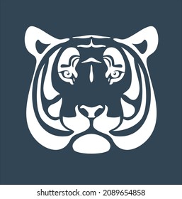 The symbol of the new year is the black water tiger. White silhouette of a tiger head isolated on a dark blue gray background.