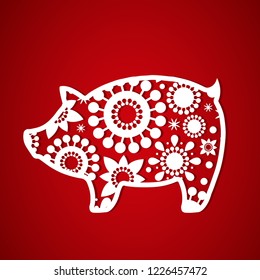 The symbol of the new year pig. Decorative template for laser cutting, plotting cutting, printing. Vector image on a red background.