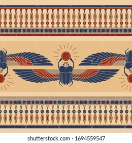 Symbols of ancient Egypt in the form of a rogue horizontal pattern with an illustration of a scarab beetle with a sun symbol in its paws and wings.