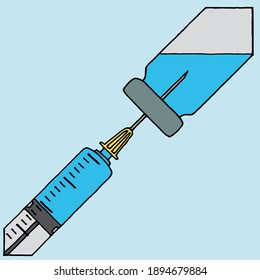 The syringe draws liquid from the vial. Vaccination against coronavirus.