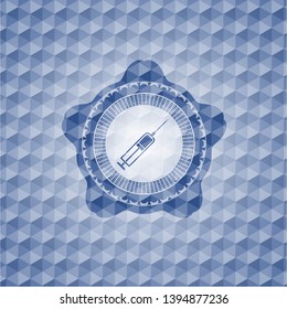 syringe icon inside blue emblem or badge with abstract geometric pattern background.