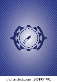 syringe icon inside emblem with denim texture