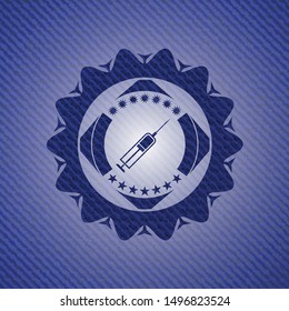syringe icon inside emblem with denim high quality background