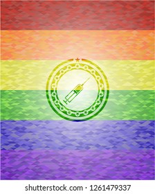 syringe icon inside emblem on mosaic background with the colors of the LGBT flag