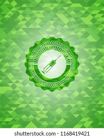 syringe icon inside green emblem with mosaic background