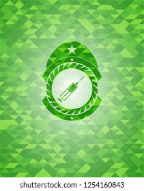 syringe icon inside green emblem with mosaic ecological style background