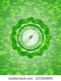 syringe icon inside green emblem with triangle mosaic background