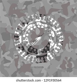 syringe icon inside grey camo emblem