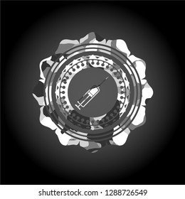 syringe icon inside grey camouflage emblem