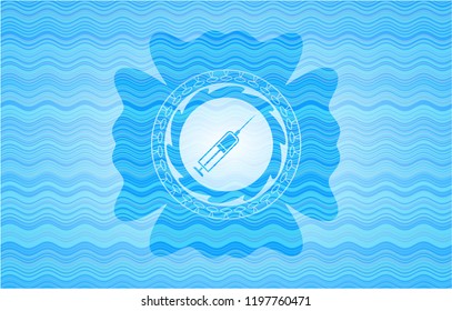 syringe icon inside light blue water wave style badge.