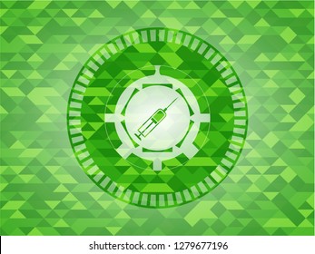 syringe icon inside realistic green emblem. Mosaic background
