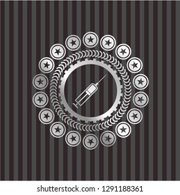 syringe icon inside silver emblem or badge