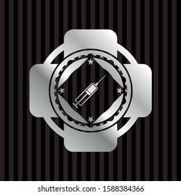 syringe icon inside silver shiny emblem