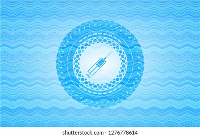 syringe icon inside water concept badge.