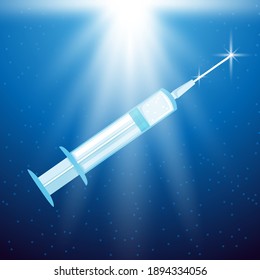 Syringe with vaccine in the rays of light on a blue background.