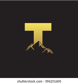 T alphabet mountain negative space letter logo gold black background