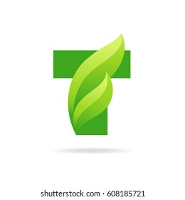 T icon with green leaves. Vector eco design.