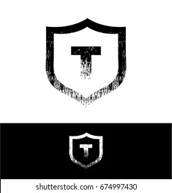 T letter Logo in shield grunge design vector