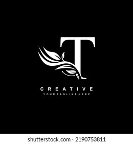 T letter logo vector design with leaf decoration. monogram T, typography. feather logo. luxury T. T flourish. suitable for logo of business, company, product, boutique, wedding, hotel, etc
