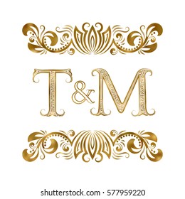 T and M vintage initials logo symbol. The letters are surrounded by ornamental elements. Wedding or business partners monogram in royal style.