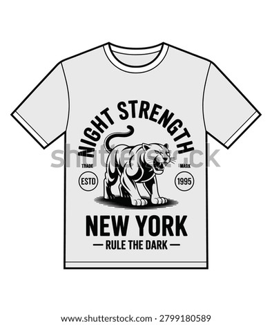 A t shirt mockup featuring a fierce panther graphic and bold typography. The black monochrome design uses a vintage athletic aesthetic for urban apparel brands. It showcases a growling wild cat centered between text elements on a light gray garment background.