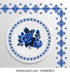 Table appointments in restaurant.. Decorative plate with round ethnic ornament and rose bouquet. Ukrainian style.  Folk pattern. Vintage background of napkin. Blue tones.