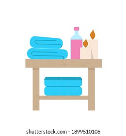 A table with bath accessories: shampoo, towel, candles. On a white background.